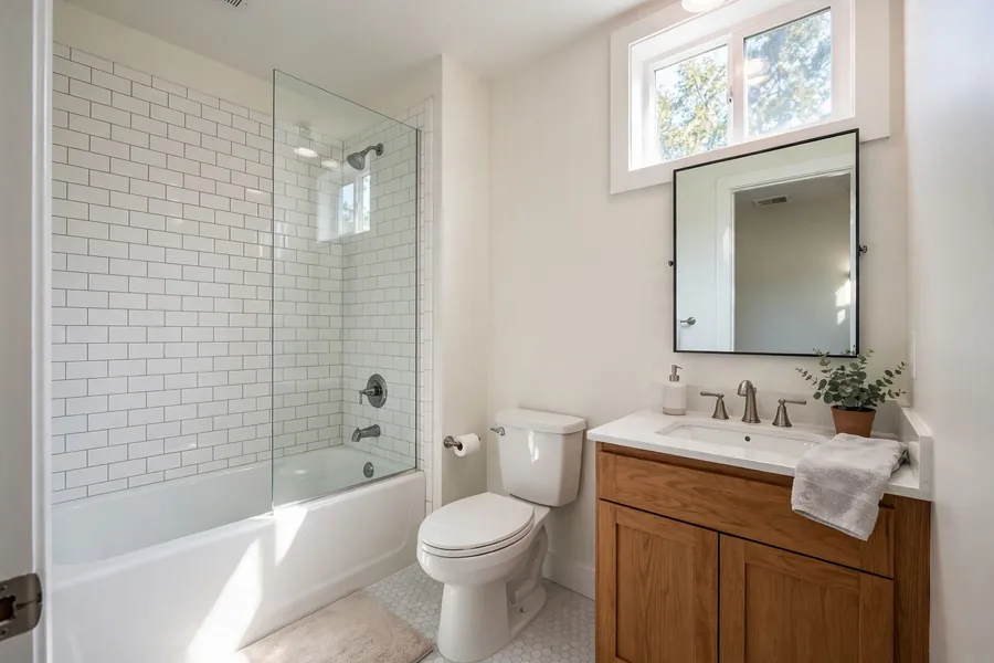 Small bathroom with a tub and shower combination, toilet, and single vanity