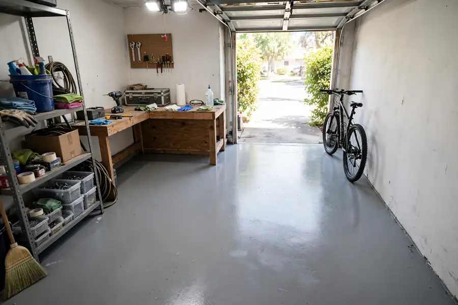 Small garage with a plain epoxy floor