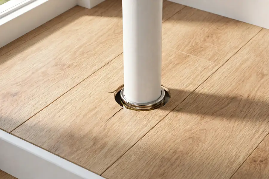 Laminate flooring fitted neatly around a pipe