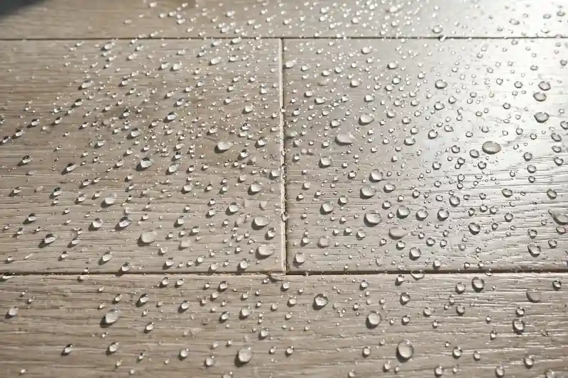 Water droplets on a click-lock vinyl floor surface
