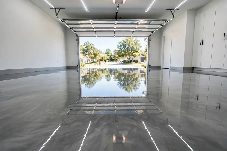 Glossy epoxy garage floor with a smooth reflective finish