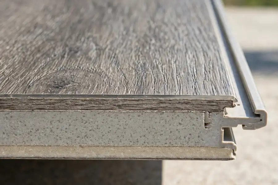 Close-up of a rigid core vinyl plank edge showing its thick core and click-lock joint