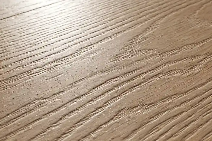 Close-up of a luxury vinyl plank floor surface showing its durable wear layer