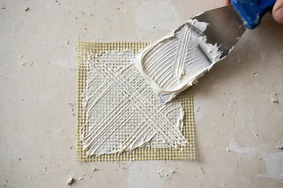 Mesh patch covered with joint compound